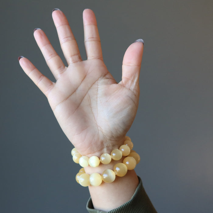 orange selenite bracelets on hand
