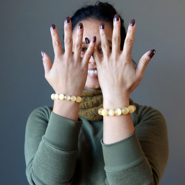 woman wearing orange selenite bracelets