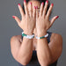 Sheila Satin of Satin Crystals shows off two of her custom design white selenite and green malachite crystal bracelets