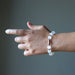 hand wearing white selenite and antique beads stretch bracelet