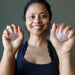 sheila of satin crystals holding two white selenite hearts