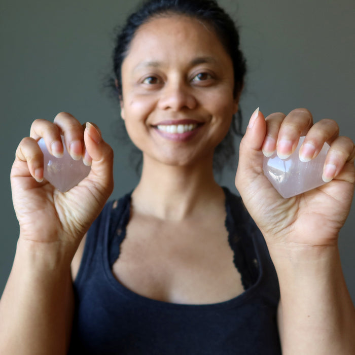 sheila of satin crystals holding two selenite hearts
