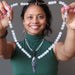 sheila of satin crystals holding selenite goddess necklace