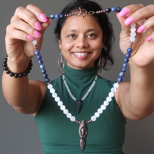 sheila of satin crystals holding selenite goddess necklace