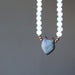 showing back of selenite sodalite wolf necklace