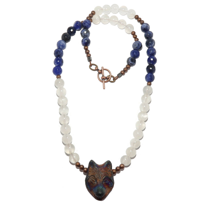wolf head pendant beaded with white selenite and faceted sodalite beads on necklace secured with toggle clasp