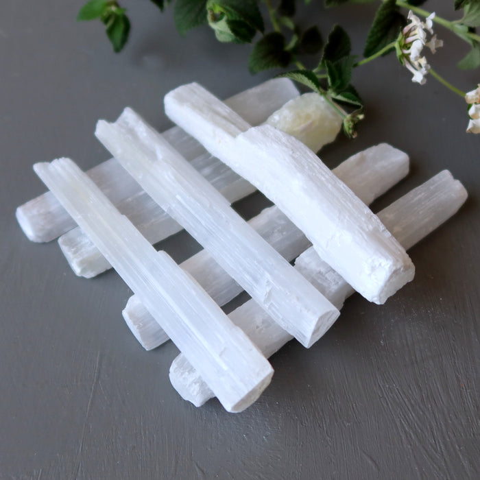 7 raw white selenite sticks stacked up