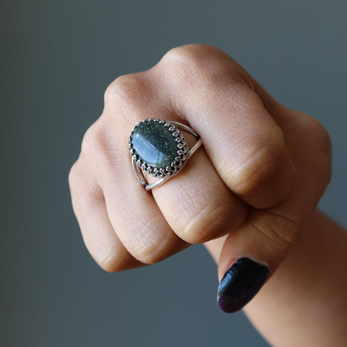 fist wearing russian serpentine sterling silver adjustable ring on middle finger