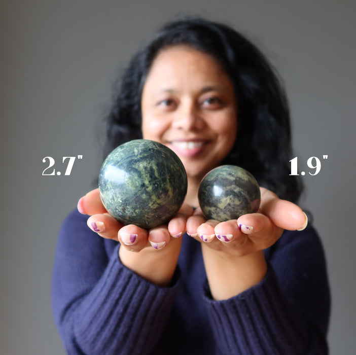 sheila holding 2 Serpentine Spheres one on each hand
