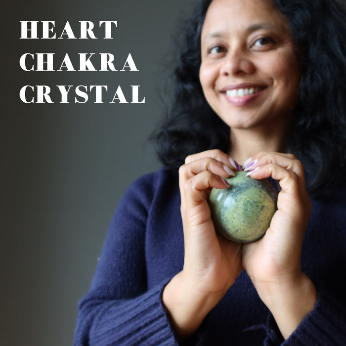 sheila holding Serpentine Spheres at heart chakra
