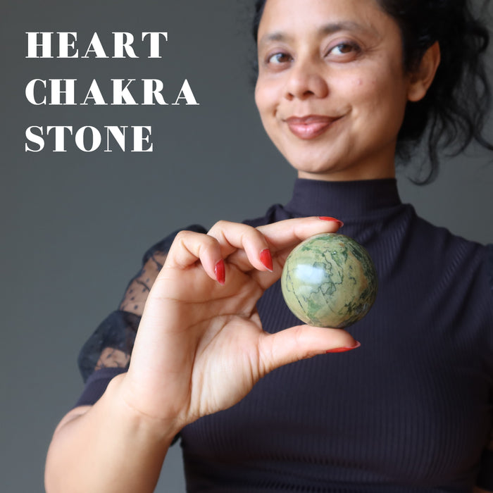sheila holding Serpentine Sphere at heart chakra