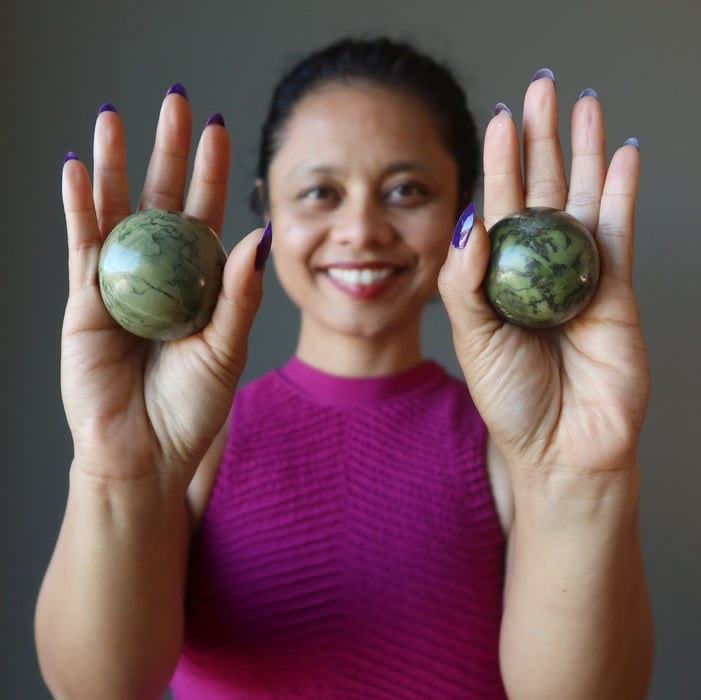 sheila holding Serpentine Spheres on both hands