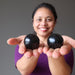 sheila of satin crystals holding two shungite spheres in her hands