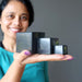 woman holding three shungite cube in different sizes