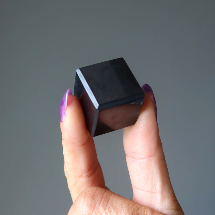 hand holding shungite cube