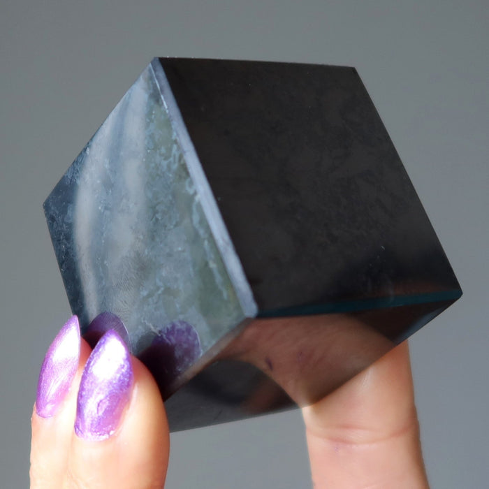 hand holding shungite cube