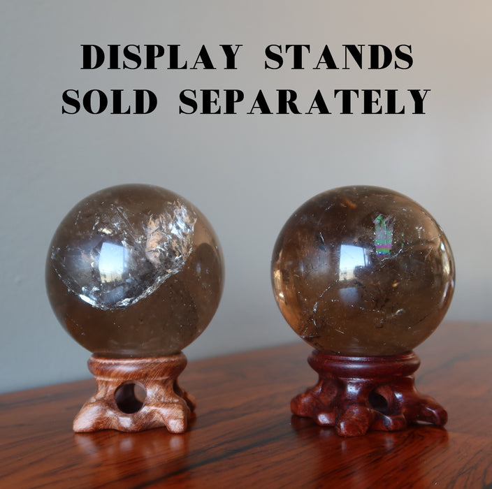 2 smoky quartz sphere on wood display stand that is sold separately