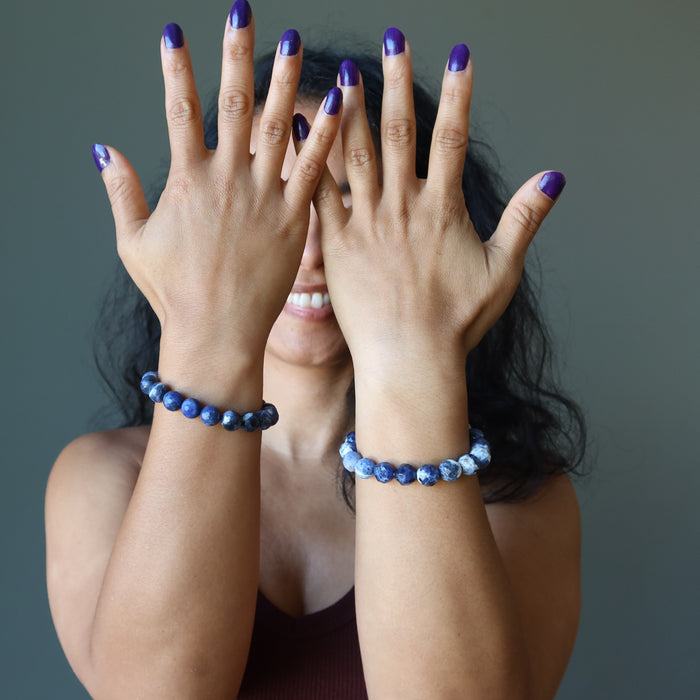 model wearing a sodalite bracelet on each wrist