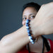 Sheila of Satin Crystals showing her hand made Sodalite bead bracelet on her wrist