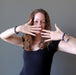 Lady with brown hair modeling three blue sodalite gemstone bracelets on her wrists