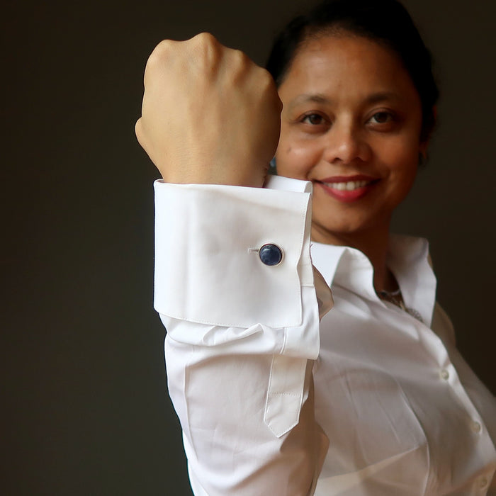 sheila of satin crystals wearing round blue sodalite stones in silver cufflinks on a white french cuff shirt