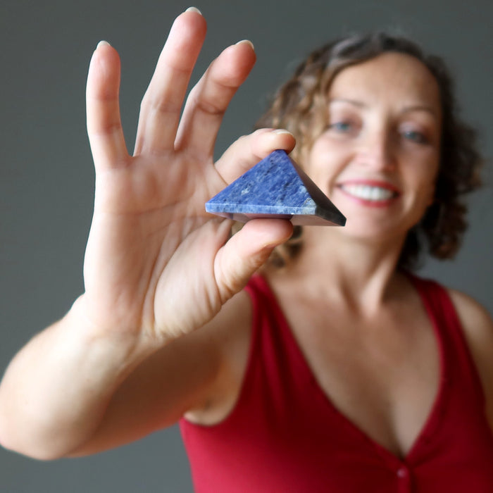 woman holding sodalite pyramid