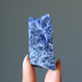 holding Raw Sodalite Crystal with finger tips