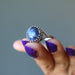 displaying Sterling Silver Adjustable Sodalite Ring on the edge of fingers