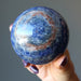hand holding blue sodalite sphere