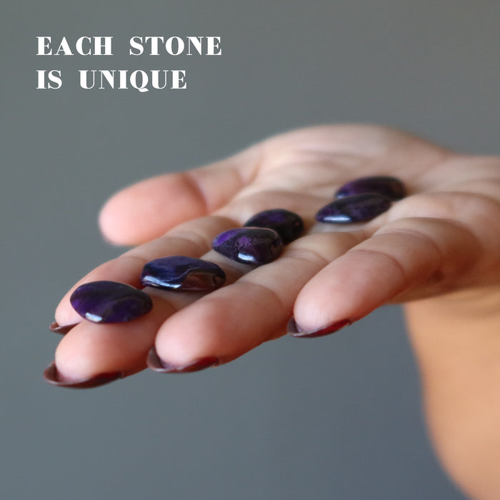 6 Sugilite Polished Stones on the palm