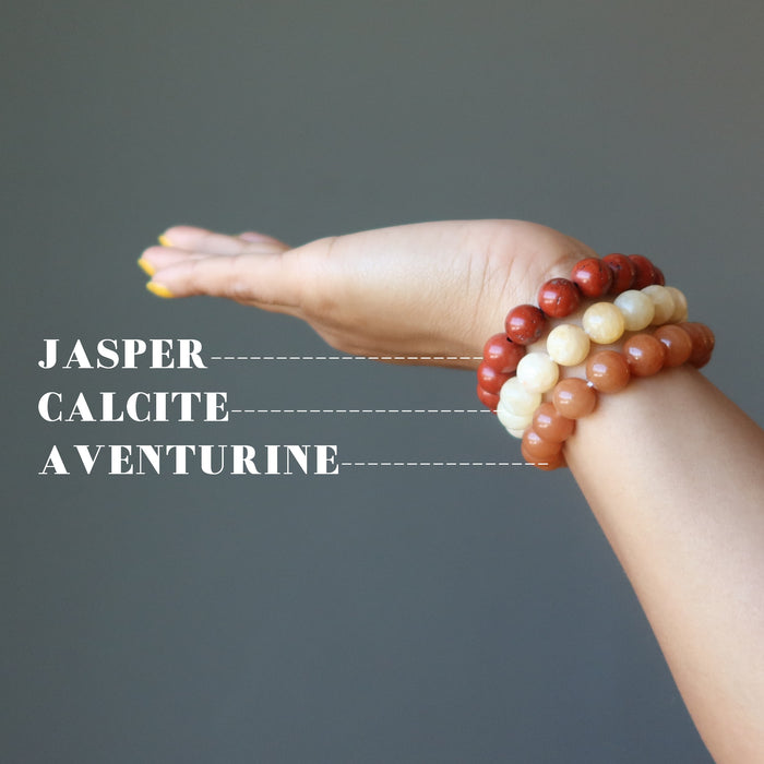 hand wearing yellow calcite, orange aventurine, red jasper stretch bracelet set 
