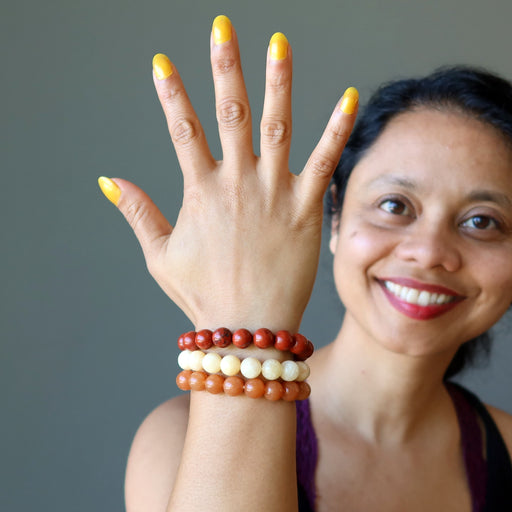 sheila of satin crystals wearing yellow calcite, orange aventurine, red jasper stretch bracelet set