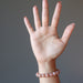 hand wearing sunstone bracelet at the wrist