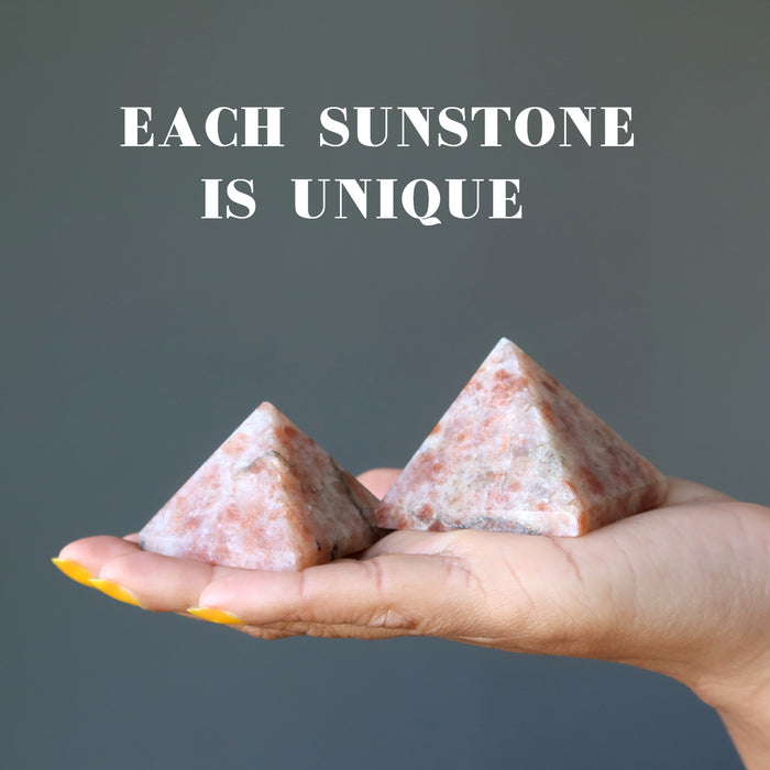 hand holding sunstone pyramids