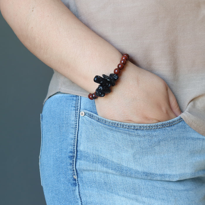 woman with hands in pocket wearing tektite obsidian bracelet