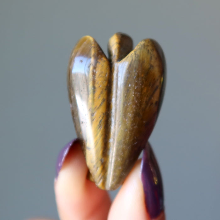 displaying back of Tigers Eye Angel with finger tips 