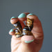 finger tips holding 2 Tigers Eye Cats