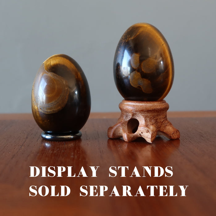one Tigers Eye egg on the ring stand the other on wood stand