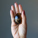holding tigers eye egg in her palm