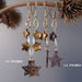 24" and 29" tigers eye earrings hand on the brown dried branch