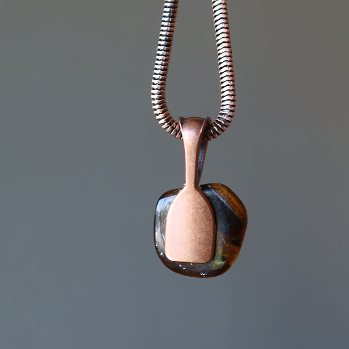 backside of golden brown tigers eye tumbled stone on antique copper necklace