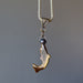 backside of tigers eye dolphin and black ball pendant on thick metal necklace