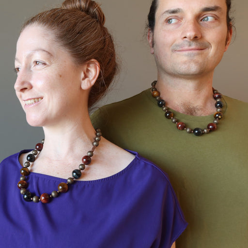 kendrick and jamie of satin crystals wearing golden, blue and red tigers eye on antiqued beaded necklace