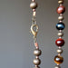 lobster claw clasp of golden, blue and red tigers eye on antiqued beaded necklace