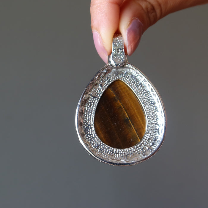 backside of golden brown tigers eye teardrop in silver pendant
