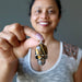 sheila of satin crystals holding golden brown tigers eye in aviator skull pendant