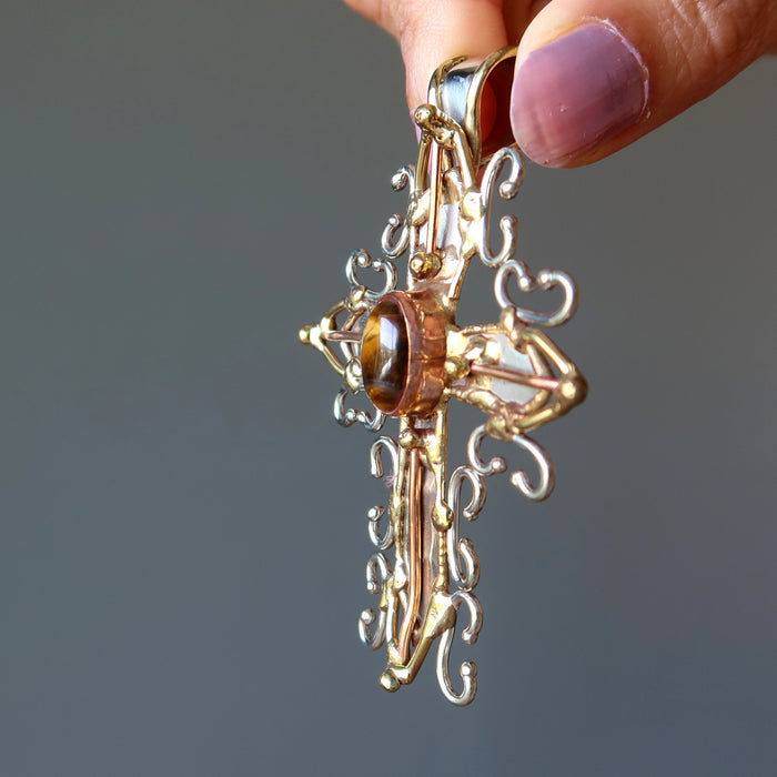 golden tigers eye oval in fancy metal cross pendant