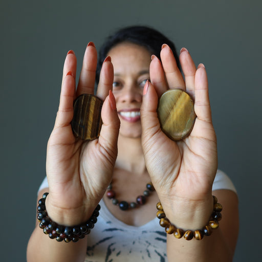 sheila of satin crystals holding two tigers eye slabs one on each hand