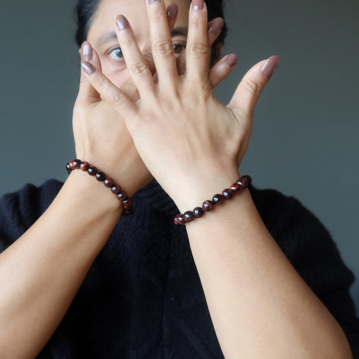 red tigers eye bracelet on woman