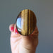 hand holding tigers eye ring